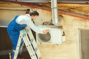 Worker fixing AC