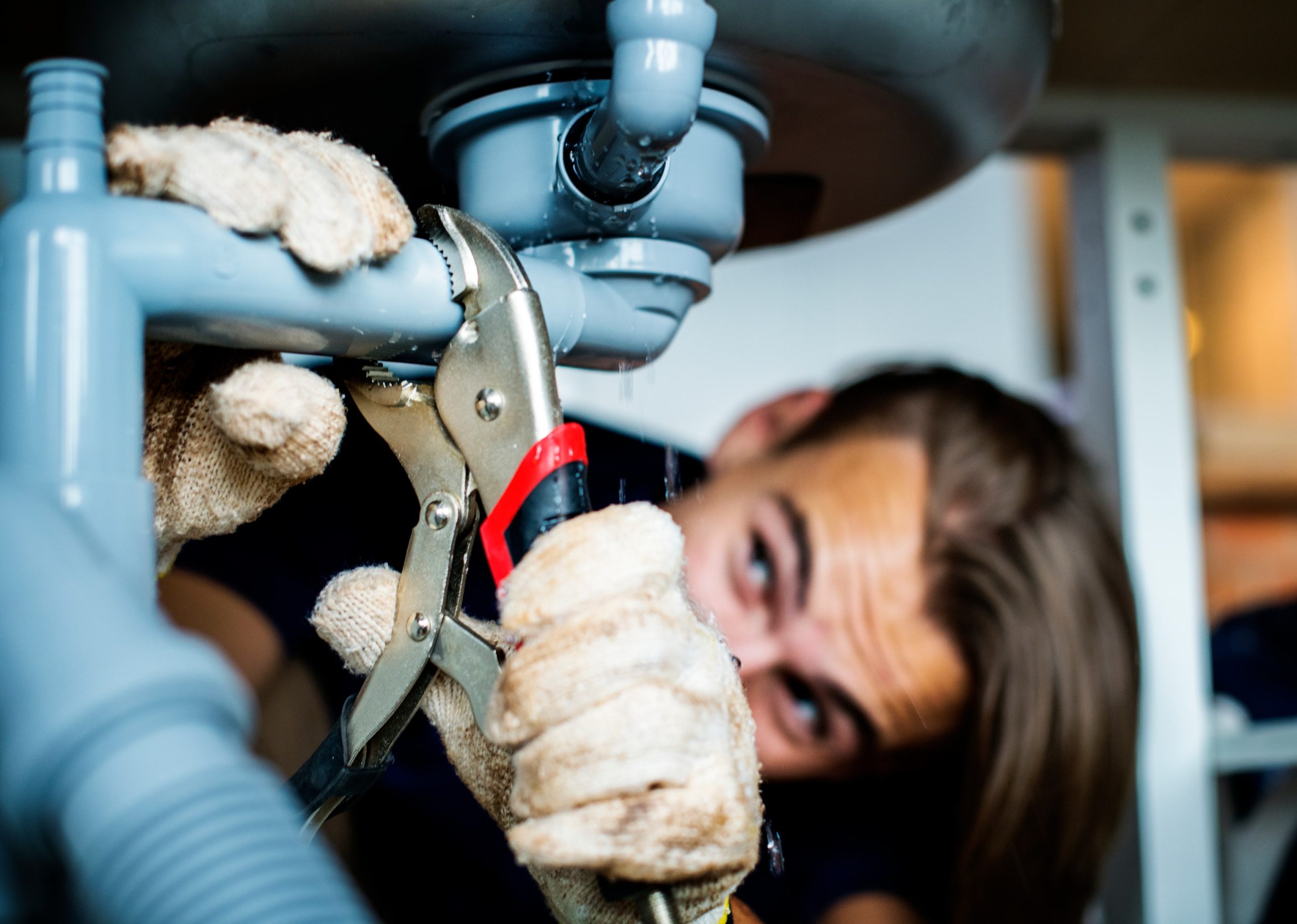 Man fixing a leaky pipe